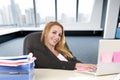 Relaxed 40s woman with blond hair smiling confident sitting on office chair working at laptop computer Royalty Free Stock Photo