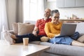 Relaxed senior couple resting together on couch at home Royalty Free Stock Photo