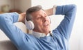 Relaxed Senior Man In Headphones Listening To Music At Home Royalty Free Stock Photo