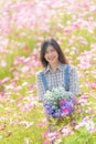 Relaxed serene and carefree pretty asian woman at flower garden in Chiangmai, concept photo of travel and freedom