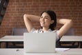 Relaxed smiling asian businesswoman take break to rest at workplace Royalty Free Stock Photo