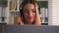 Relaxed smiling Caucasian woman student girl entrepreneur take work break at office listen to music in headphones enjoy Royalty Free Stock Photo