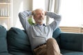 Relaxed smiling middle aged man sleeping on comfortable couch. Royalty Free Stock Photo