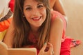 Relaxed smiling woman, reading lying on the floor Royalty Free Stock Photo