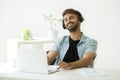 Relaxed young man in headphones enjoying music on laptop Royalty Free Stock Photo