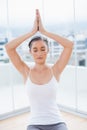 Relaxed sporty brunette sitting in yoga posture