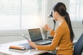Relaxed stock exchange trader or businesswoman working with a stock market dashboard, analyzing trading data, graphs