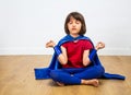 Relaxed superhero child relaxing with yoga, mindfulness, meditation, bare feet