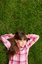 Relaxed teenage girl lying in grass. lifestyle, summer vacation and people concept. Royalty Free Stock Photo