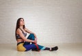 Relaxed thoughtful woman resting after fitness exercises looking