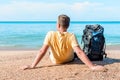 Relaxed tourist with a backpack near the sea