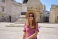 Relaxed tourist girl strolling in the old town of Otranto, Apulia, Italy