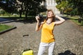 Relaxed traveler tourist woman with closed eyes in hat with suitcase keeping hand on head hold retro vintage photo Royalty Free Stock Photo