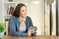 Relaxed woman contemplating at home