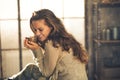 Relaxed woman with cup of coffee in loft apartment Royalty Free Stock Photo