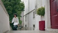 Relaxed woman going upstairs at empty street. Girl walking cozy city at vacation