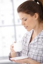 Relaxed woman having morning coffee