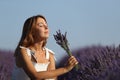 Woman holding bouquet smelling flowers in a lavender field Royalty Free Stock Photo