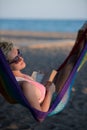 Relaxed woman laying in hammock Royalty Free Stock Photo