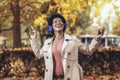 Woman listening to music and breathing fresh air in autumn in a forest or park Royalty Free Stock Photo