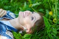 Relaxed woman listening to the music with headphones lying on the grass Royalty Free Stock Photo