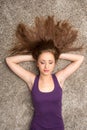 Relaxed woman lying on floor indoors and sleeping. Royalty Free Stock Photo