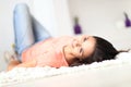 Relaxed woman lying on the floor indoors Royalty Free Stock Photo