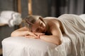 Relaxed woman lying in spa with closed eyes, waiting for massage. Girl having relaxing in spa massage salon. Royalty Free Stock Photo