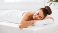 Relaxed woman lying in spa salon with closed eyes Royalty Free Stock Photo