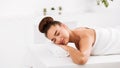 Relaxed woman lying in spa salon with closed eyes Royalty Free Stock Photo