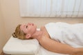 Woman lying in spa salon with closed eyes, waiting for massage Royalty Free Stock Photo