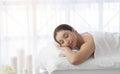 Relaxed woman lying in spa salon with closed eyes, waiting for massage Royalty Free Stock Photo