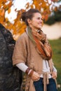 Relaxed woman near stone rock in evening autumn park Royalty Free Stock Photo
