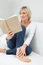 Relaxed woman reading book at home Royalty Free Stock Photo