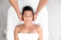 Relaxed woman receiving head massage in wellness center Royalty Free Stock Photo