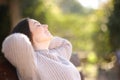 Relaxed woman resting on bench in a park Royalty Free Stock Photo