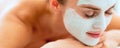 Relaxed woman with revitalising mask on face laying on mas