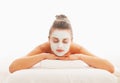 Relaxed woman with revitalising mask on face
