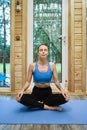 Relaxed woman sits in lotus yoga pose Royalty Free Stock Photo