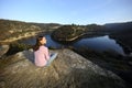 Relaxed woman sitting contemplating nature in a river