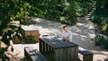 Relaxed woman speaking video meeting by cell phone sitting table picnic spot. Royalty Free Stock Photo