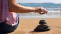 Close Up Of Relaxed Woman Stacking Stones On Peaceful Beach Vacation