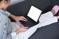 Relaxed woman using digital tablet, surfing internet, shopping online at home. Royalty Free Stock Photo