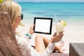 Relaxed woman using tablet computer on the beach Royalty Free Stock Photo