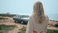 Relaxed woman walking coast at summer vacation closeup. Girl going to retro car