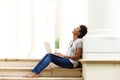 Relaxed young african woman sitting outside with her laptop Royalty Free Stock Photo