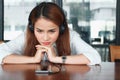 Relaxed young Asian woman listening music with headphones in living room. Royalty Free Stock Photo