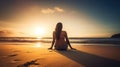 A relaxed young brunette woman or girl wearing a bikini sitting on a deserted tropical beach at sunset or sunrise