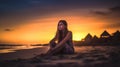 A relaxed young brunette woman or girl wearing a bikini sitting on a deserted tropical beach at sunset or sunrise