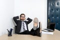 Relaxed young businessman in the office